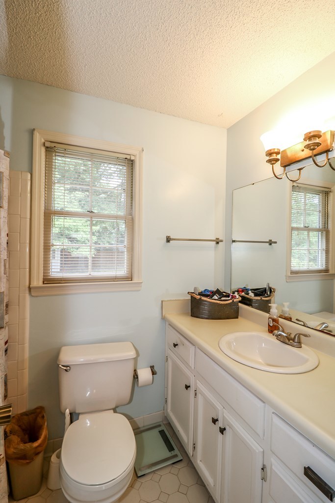 1921 Northside Road Perry, GA 31069 - Photo 20 of 49 a bathroom with a granite countertop toilet sink and mirror