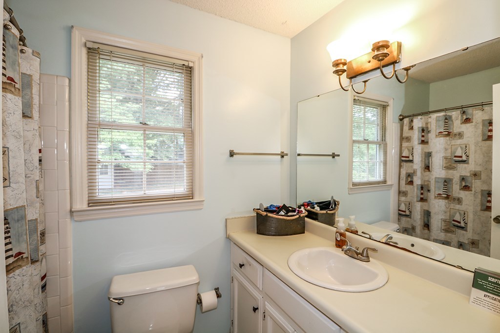 1921 Northside Road Perry, GA 31069 - Photo 21 of 49 a bathroom with a sink toilet a mirror and shower