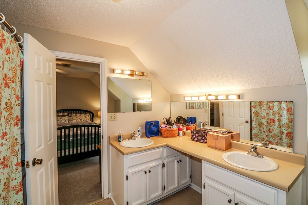 1921 Northside Road Perry, GA 31069 - Photo 24 of 49 a bathroom with a double vanity sink and a mirror