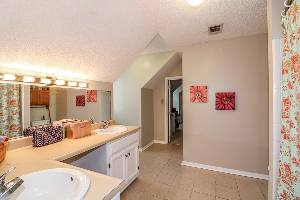 1921 Northside Road Perry, GA 31069 - Photo 25 of 49 a bathroom with a granite countertop sink and a mirror