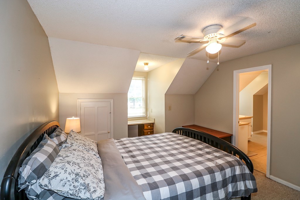1921 Northside Road Perry, GA 31069 - Photo 26 of 49 a bedroom with a large bed and a chandelier