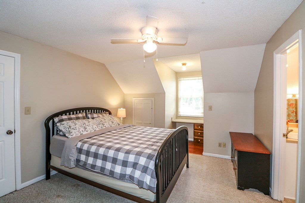 1921 Northside Road Perry, GA 31069 - Photo 27 of 49 a bedroom with a bed and a chandelier