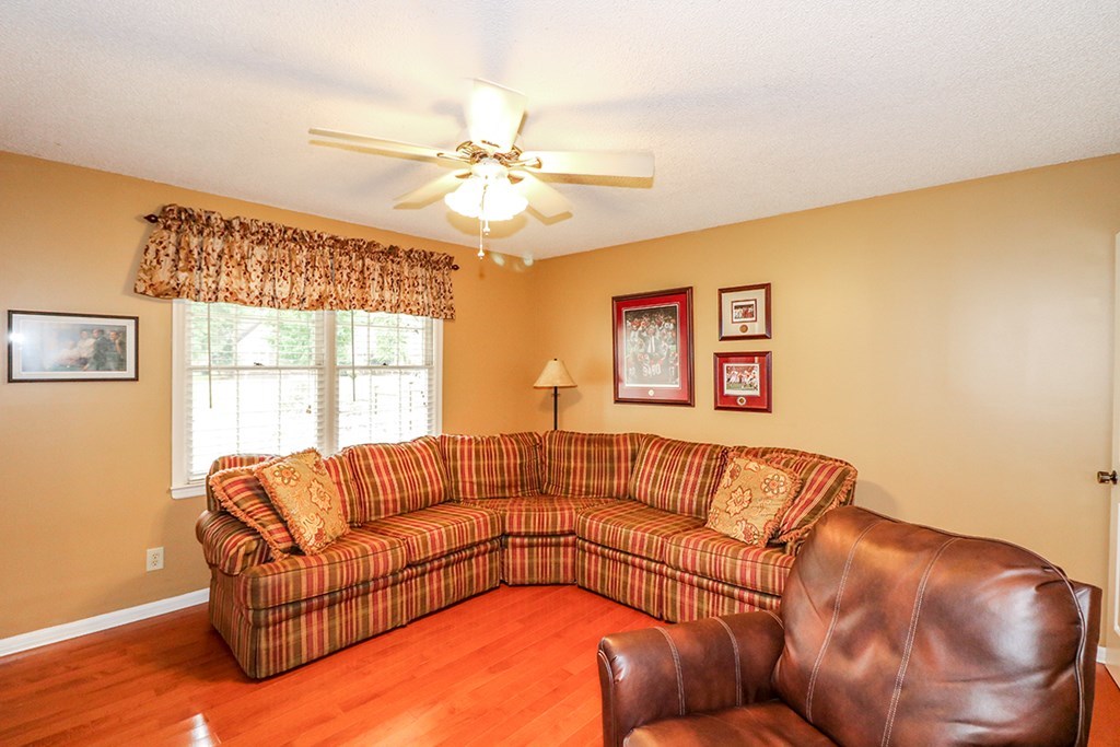 1921 Northside Road Perry, GA 31069 - Photo 34 of 49 a living room with a couch and a chandelier