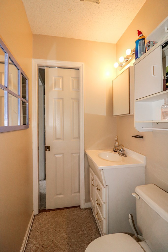 1921 Northside Road Perry, GA 31069 - Photo 39 of 49 a bathroom with a toilet sink and mirror