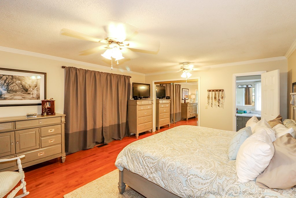 1921 Northside Road Perry, GA 31069 - Photo 42 of 49 a bedroom with a large bed and a chandelier