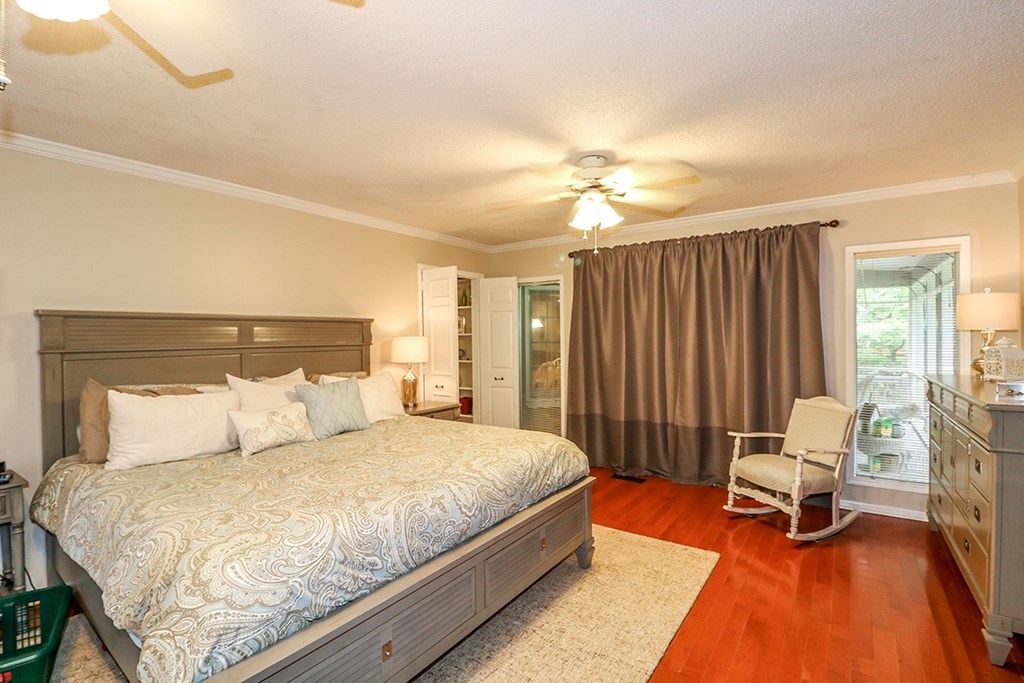1921 Northside Road Perry, GA 31069 - Photo 43 of 49 a bedroom with a bed a chair and a chandelier