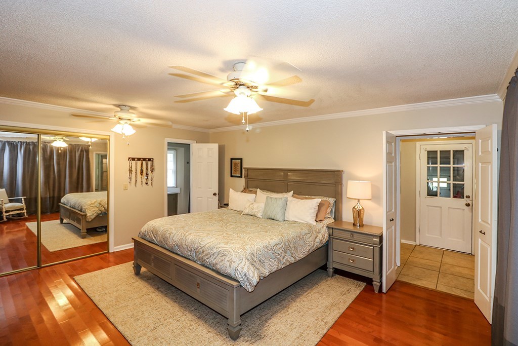 1921 Northside Road Perry, GA 31069 - Photo 44 of 49 a bedroom with a bed and a chandelier