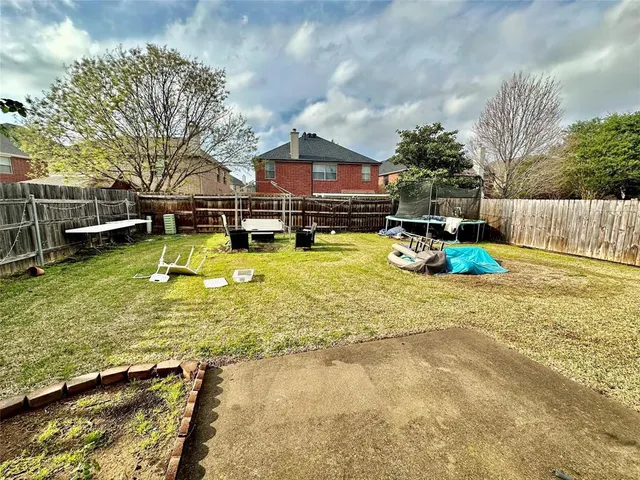 a swimming pool with outdoor seating and yard