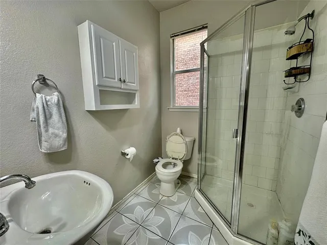 a bathroom with a sink toilet and shower