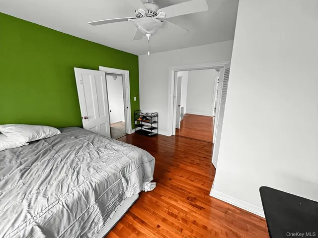 a spacious bedroom with a bed and a chair