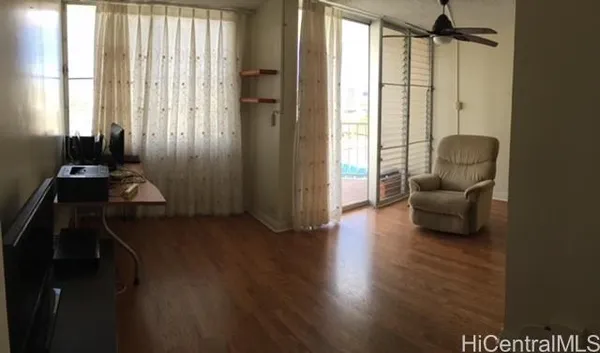 a room with wooden floor and furniture