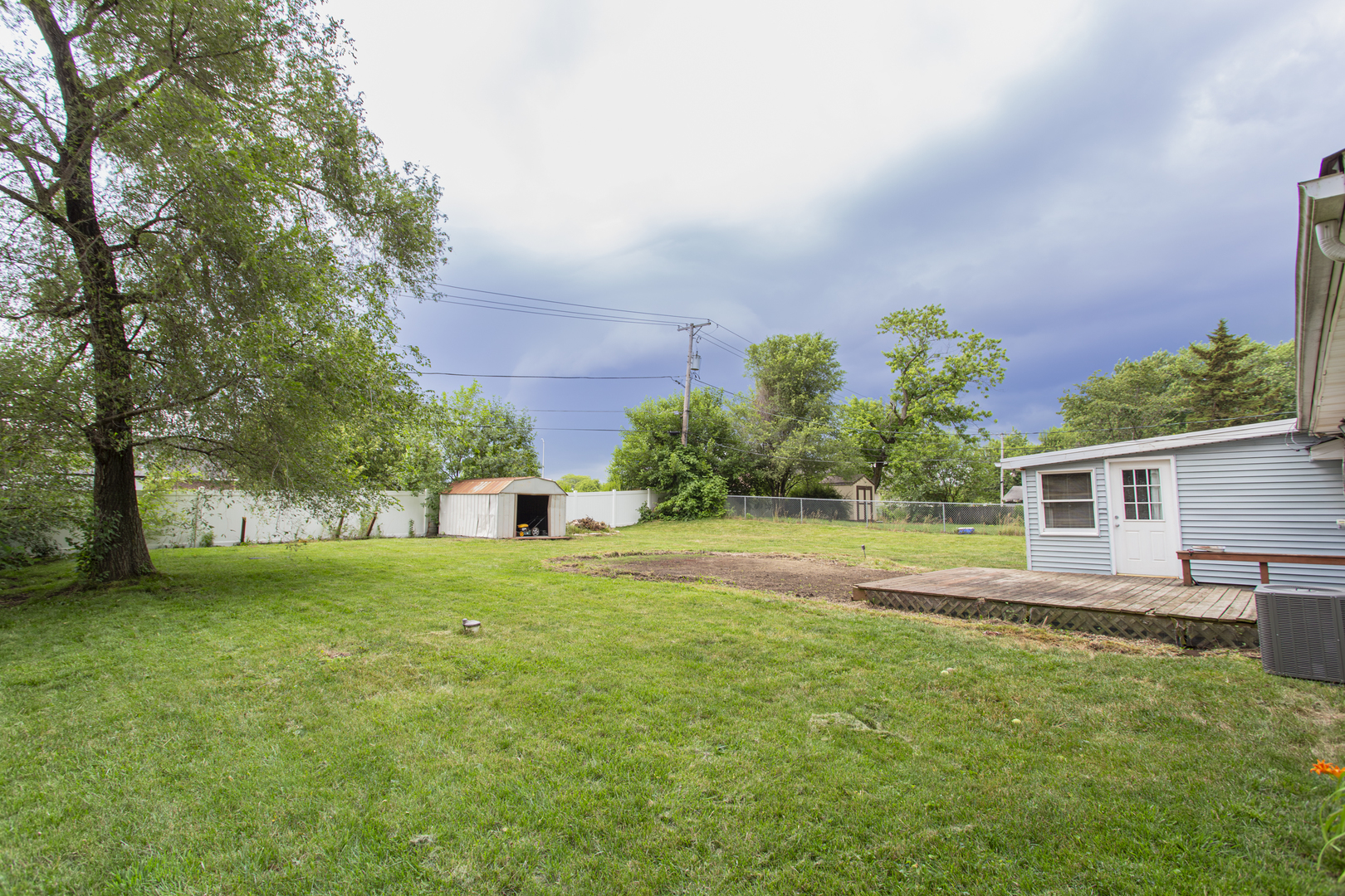 320 Hillside Road New Lenox, IL 60451 - Photo 11 of 14 a view of a house with a backyard and a garden