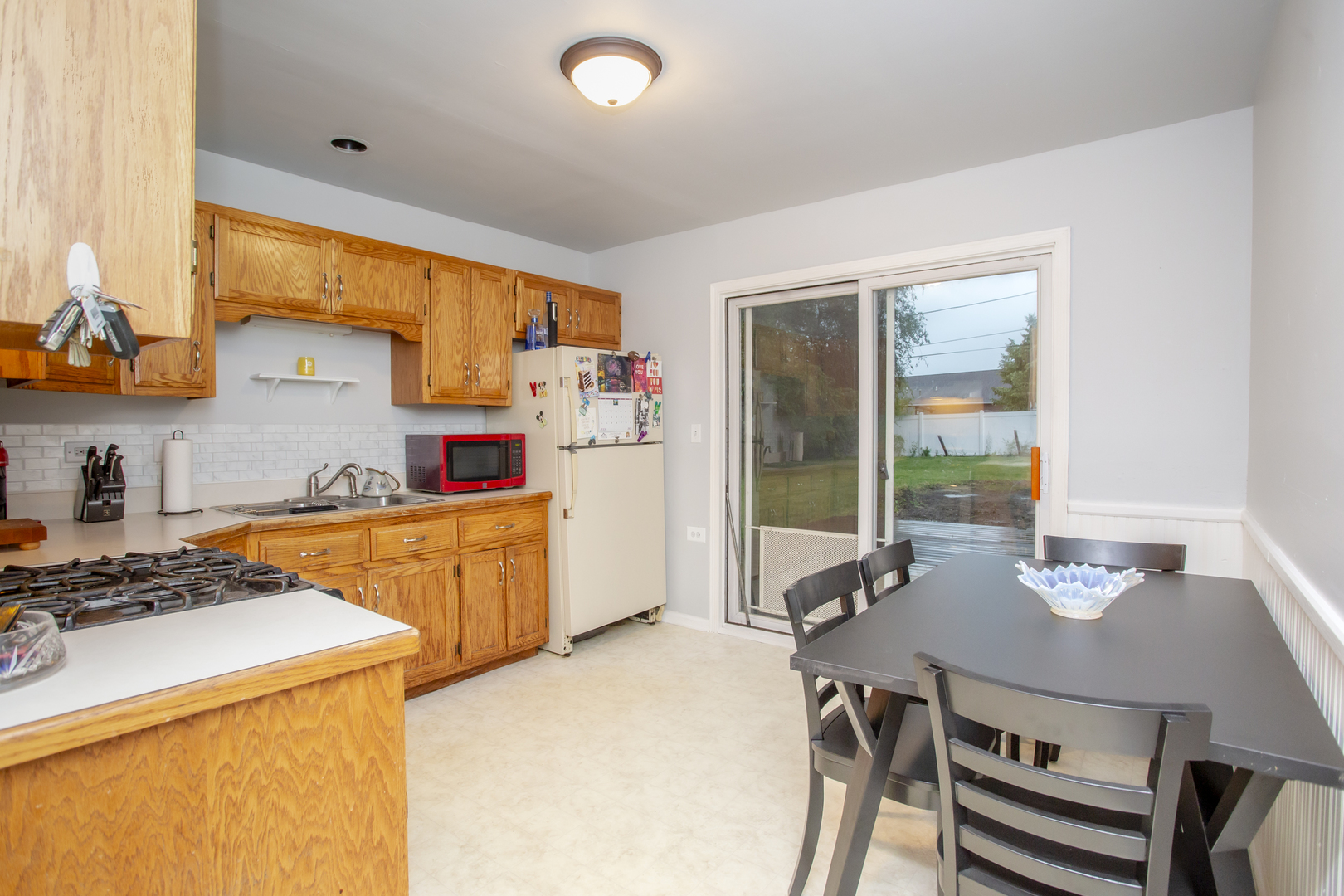 320 Hillside Road New Lenox, IL 60451 - Photo 4 of 14 a kitchen with a sink a stove and chairs