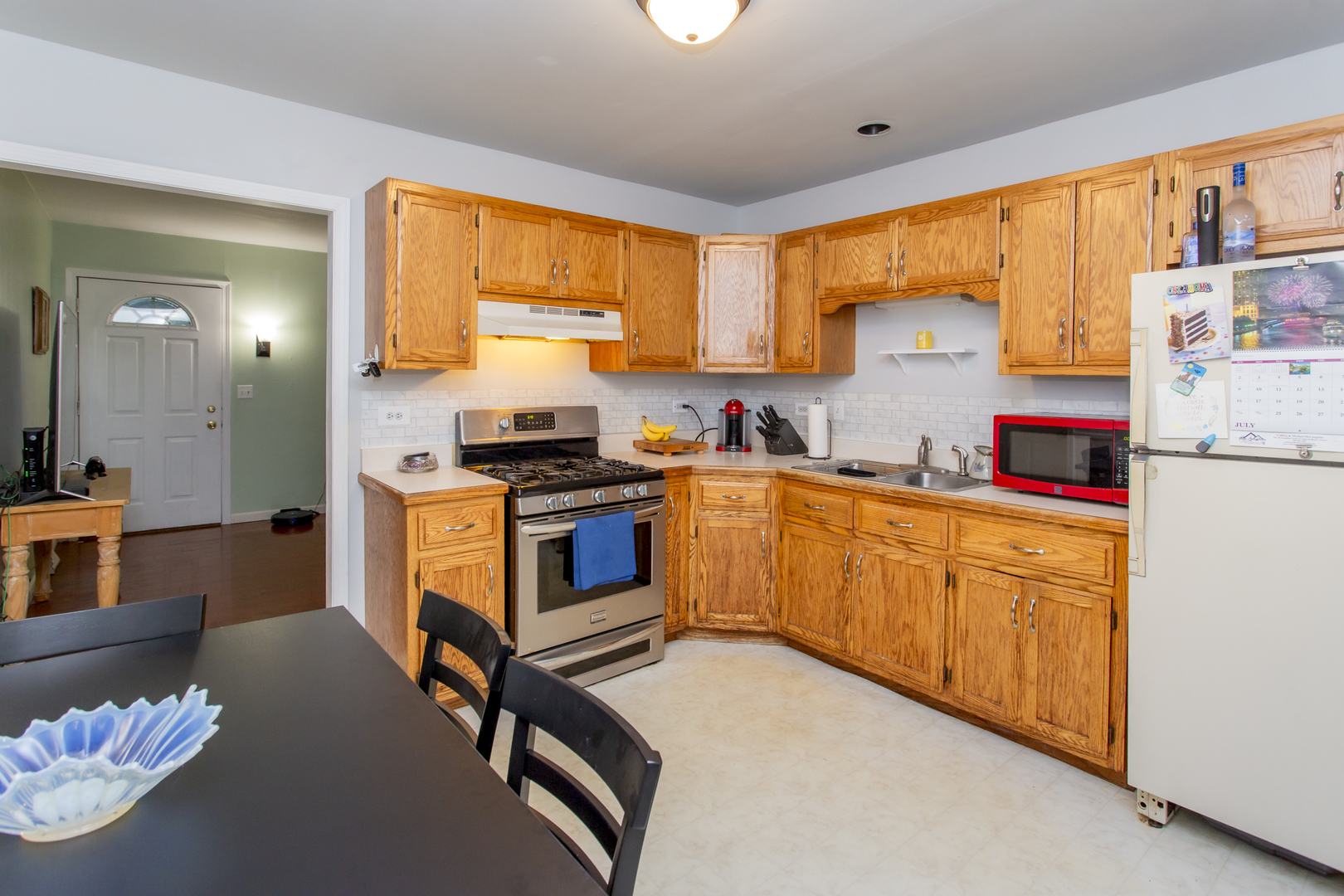 320 Hillside Road New Lenox, IL 60451 - Photo 5 of 14 a kitchen with stainless steel appliances granite countertop a stove a sink dishwasher and a refrigerator