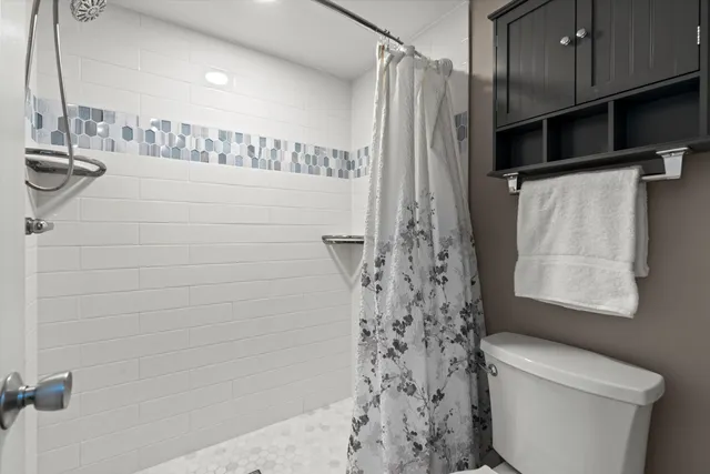 a bedroom with a large bed and a flat screen tv