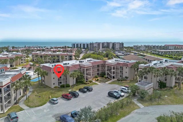 a view of a hallway with wooden floor and a living room