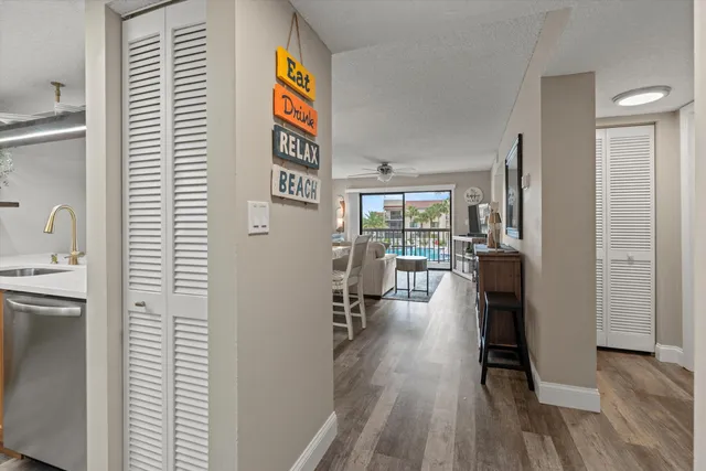 a kitchen with stainless steel appliances granite countertop a sink and a refrigerator