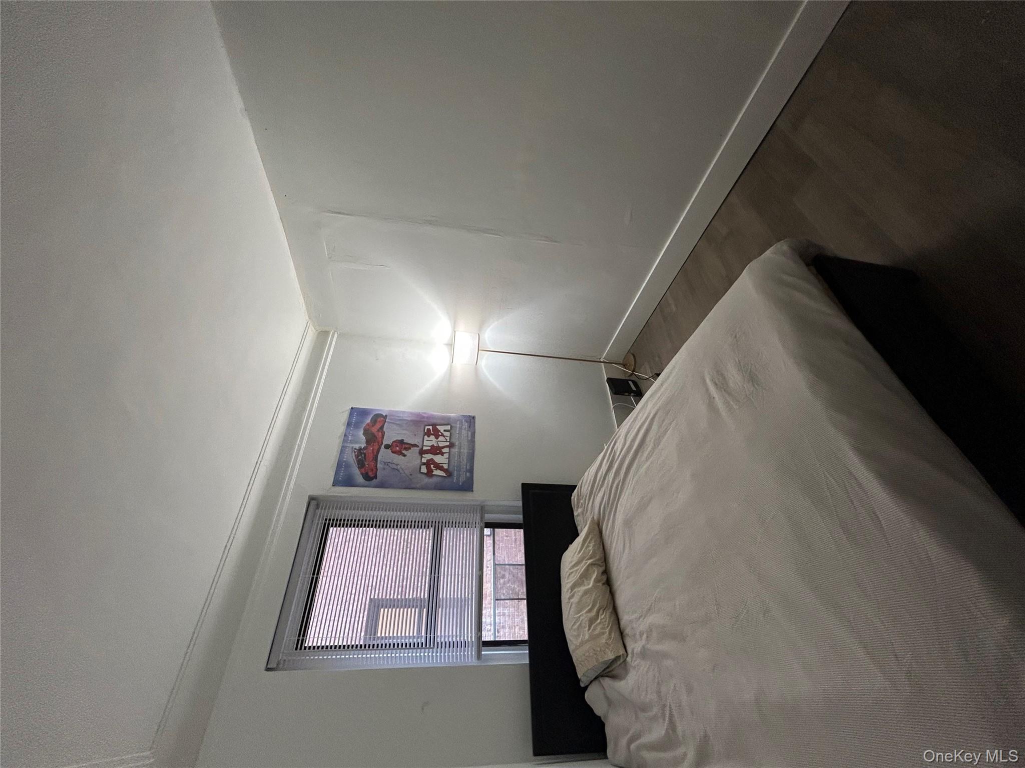 3000 Valentine Avenue, Unit 3E Bronx, NY 10458 - Photo 5 of 7 a bedroom with a bed and a window