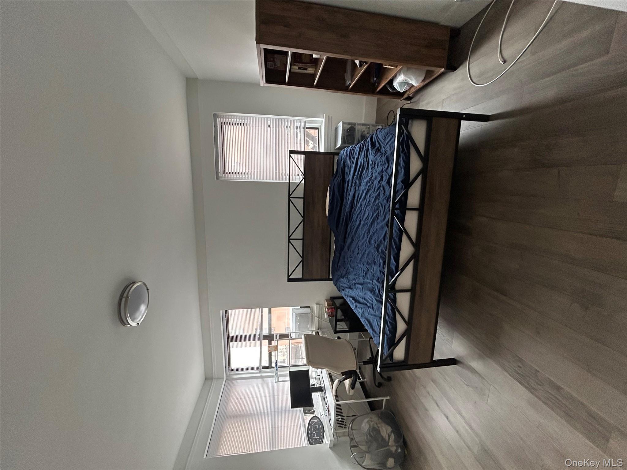 3000 Valentine Avenue, Unit 3E Bronx, NY 10458 - Photo 6 of 7 a living room with furniture flat screen tv and window