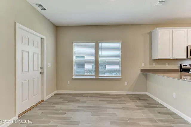 a view of an empty room with a window