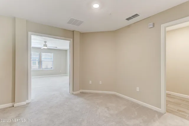 an empty room with windows and closet