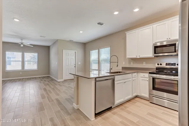 a kitchen with stainless steel appliances granite countertop a stove and a sink