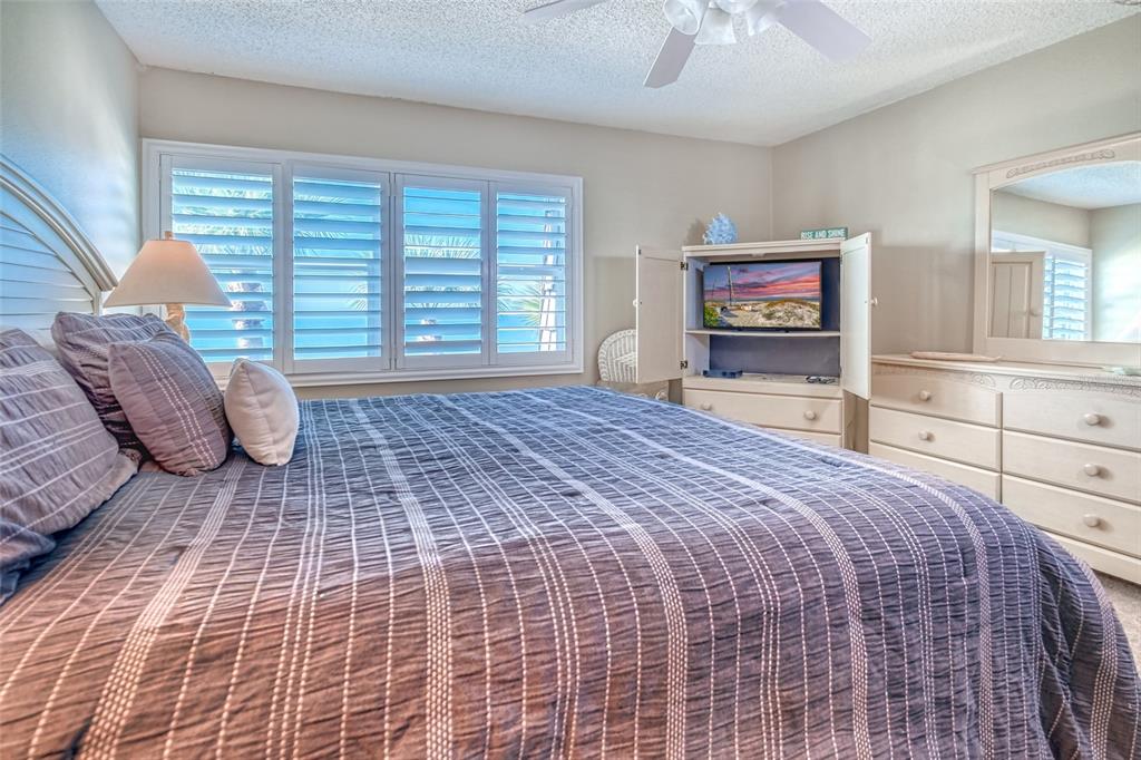 60 Gulf Boulevard, Unit 204 Indian Rocks Beach, FL 33785 - Photo 18 of 45 a bedroom with a bed and a window