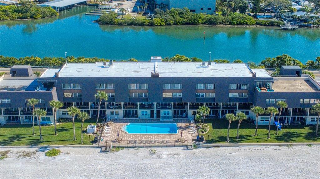 60 Gulf Boulevard, Unit 204 Indian Rocks Beach, FL 33785 - Photo 39 of 45 a view of a house with a yard and sitting area