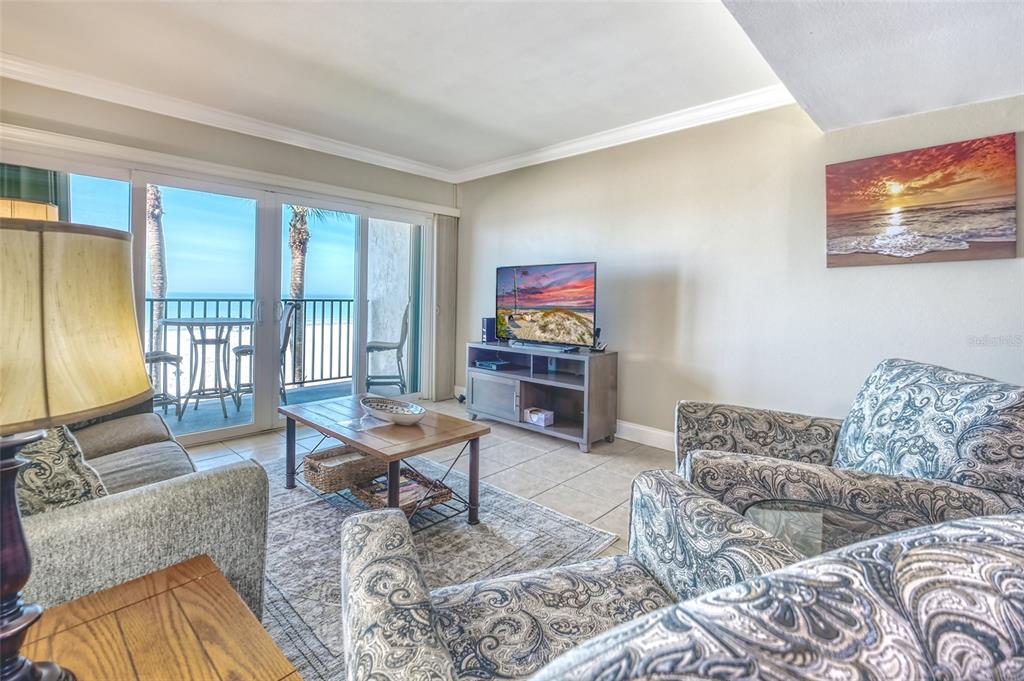 60 Gulf Boulevard, Unit 204 Indian Rocks Beach, FL 33785 - Photo 4 of 45 a living room with furniture and a flat screen tv