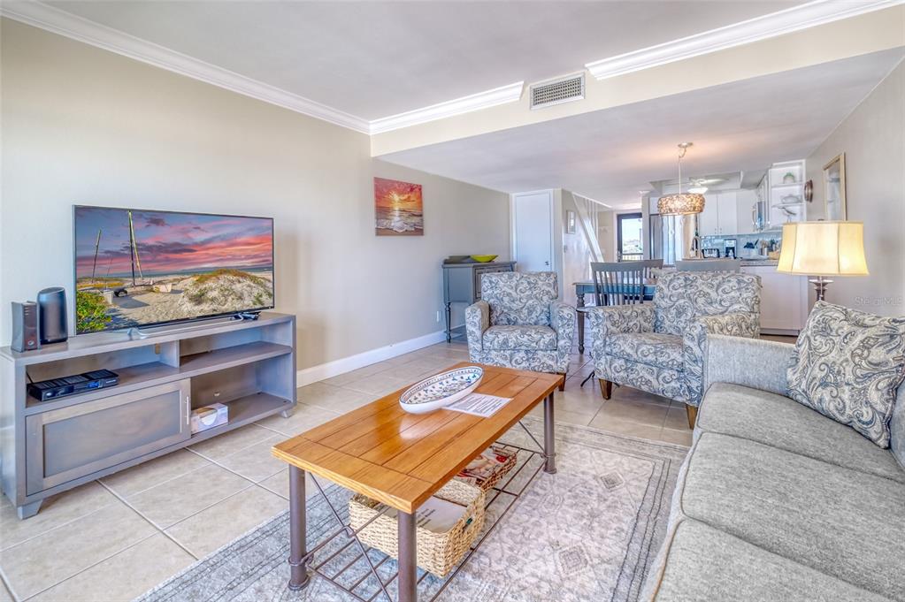 60 Gulf Boulevard, Unit 204 Indian Rocks Beach, FL 33785 - Photo 6 of 45 a living room with furniture and a flat screen tv
