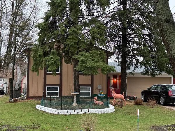 a view of a house with backyard and sitting area