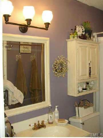 6925 Staghorn Lane Raleigh, NC 27615 - Photo 6 of 12 Master bath with cottage style decor, new fixtures, tile surround and floor is lovely. Other