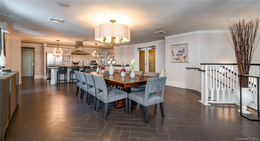 1440 Harding Place, Unit 446 Charlotte, NC 28204 - Photo 6 of 19 a view of a dining room with furniture and wooden floor