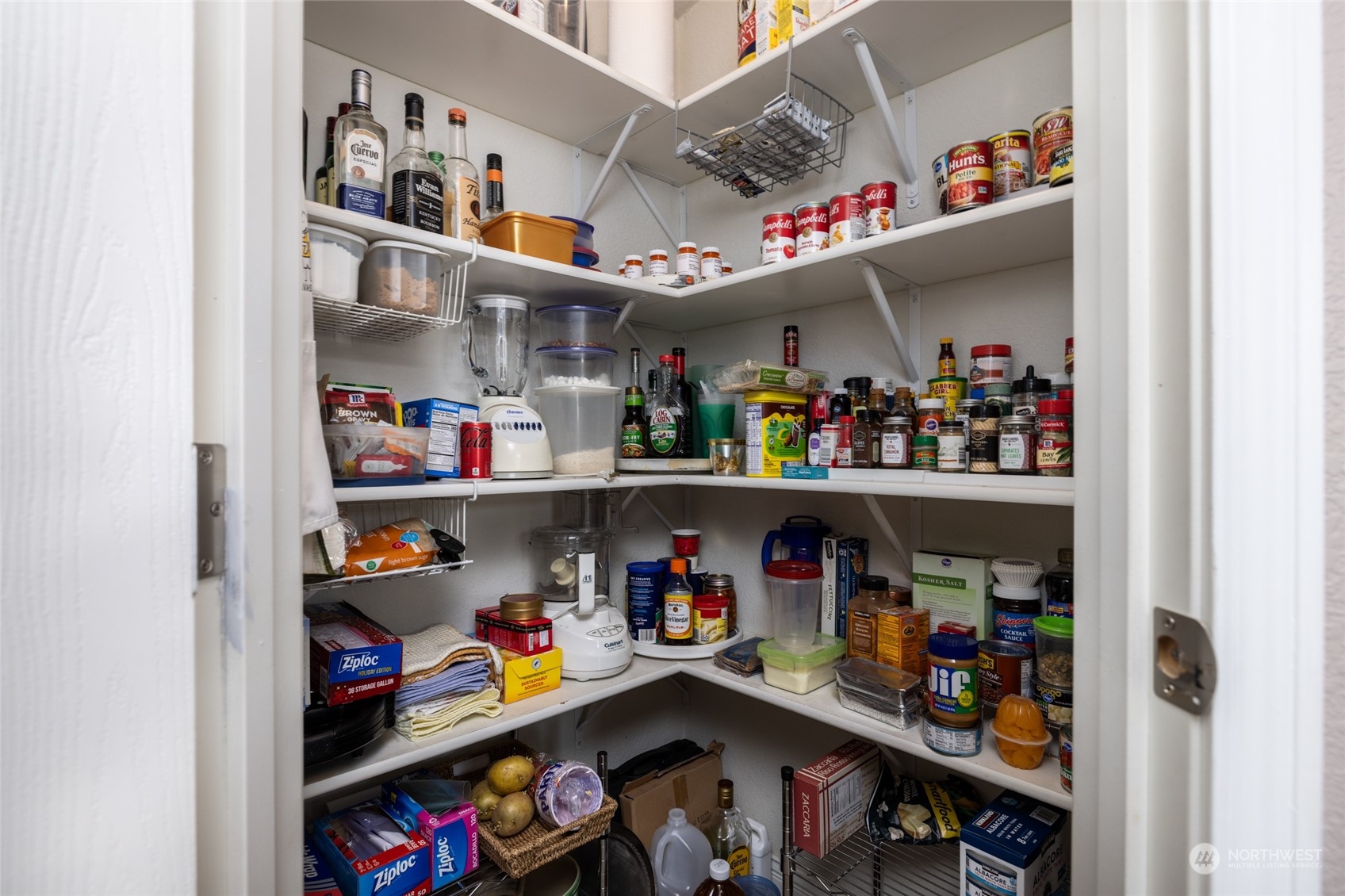 107 South Pass Road, Unit 3 Nooksack, WA 98276 - Photo 12 of 38 a store room with lots of clutter and a refrigerator