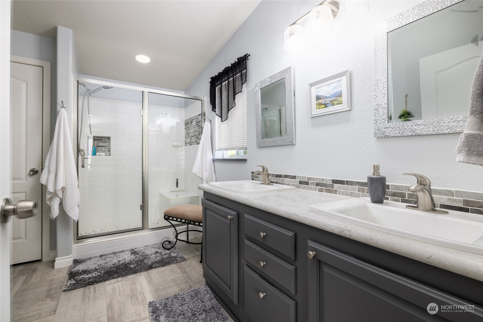 107 South Pass Road, Unit 3 Nooksack, WA 98276 - Photo 18 of 38 a spacious bathroom with a granite countertop sink a toilet a mirror and shower