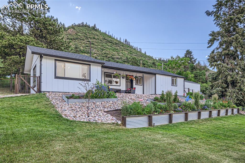 a front view of a house with a garden and plants