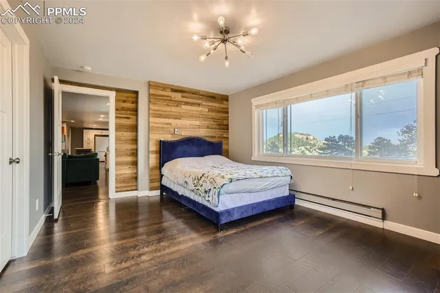 a bedroom with a large bed and a chandelier