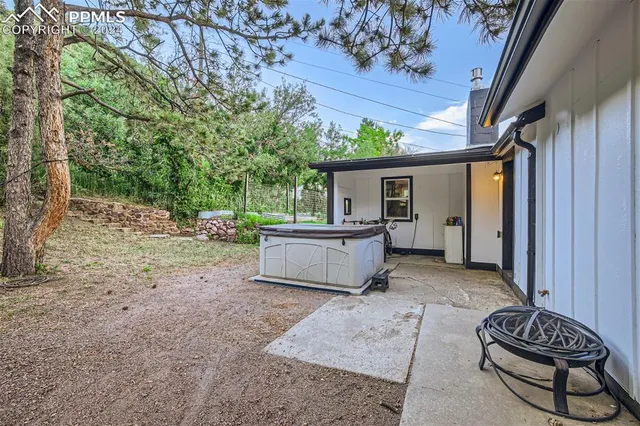 a view of a porch with furniture and a yard