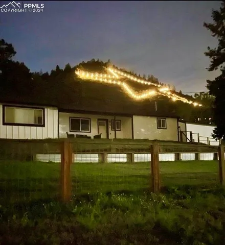 a backyard of a house with table and chairs