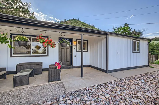 a backyard of a house with outdoor seating