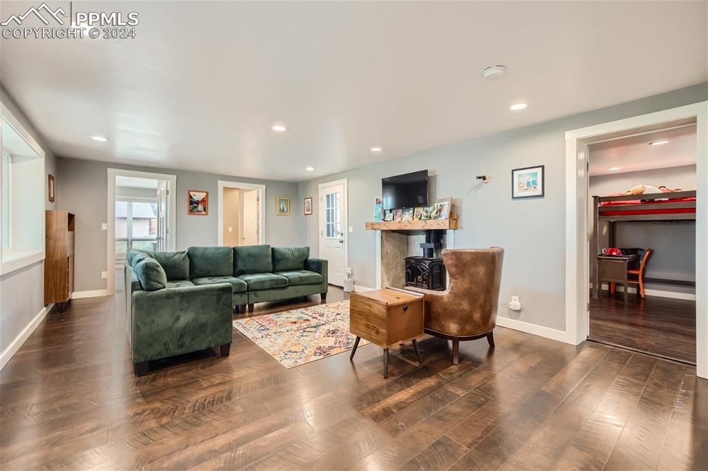 118 Hillside Road Palmer Lake, CO 80133 - Photo 5 of 25 a living room with furniture and a fireplace