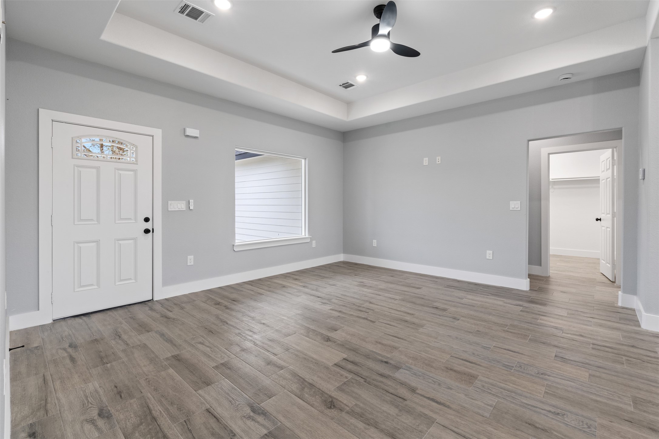7 Meadowview Drive Trinity, TX 75862 - Photo 7 of 32 an empty room with wooden floor chandelier fan and windows