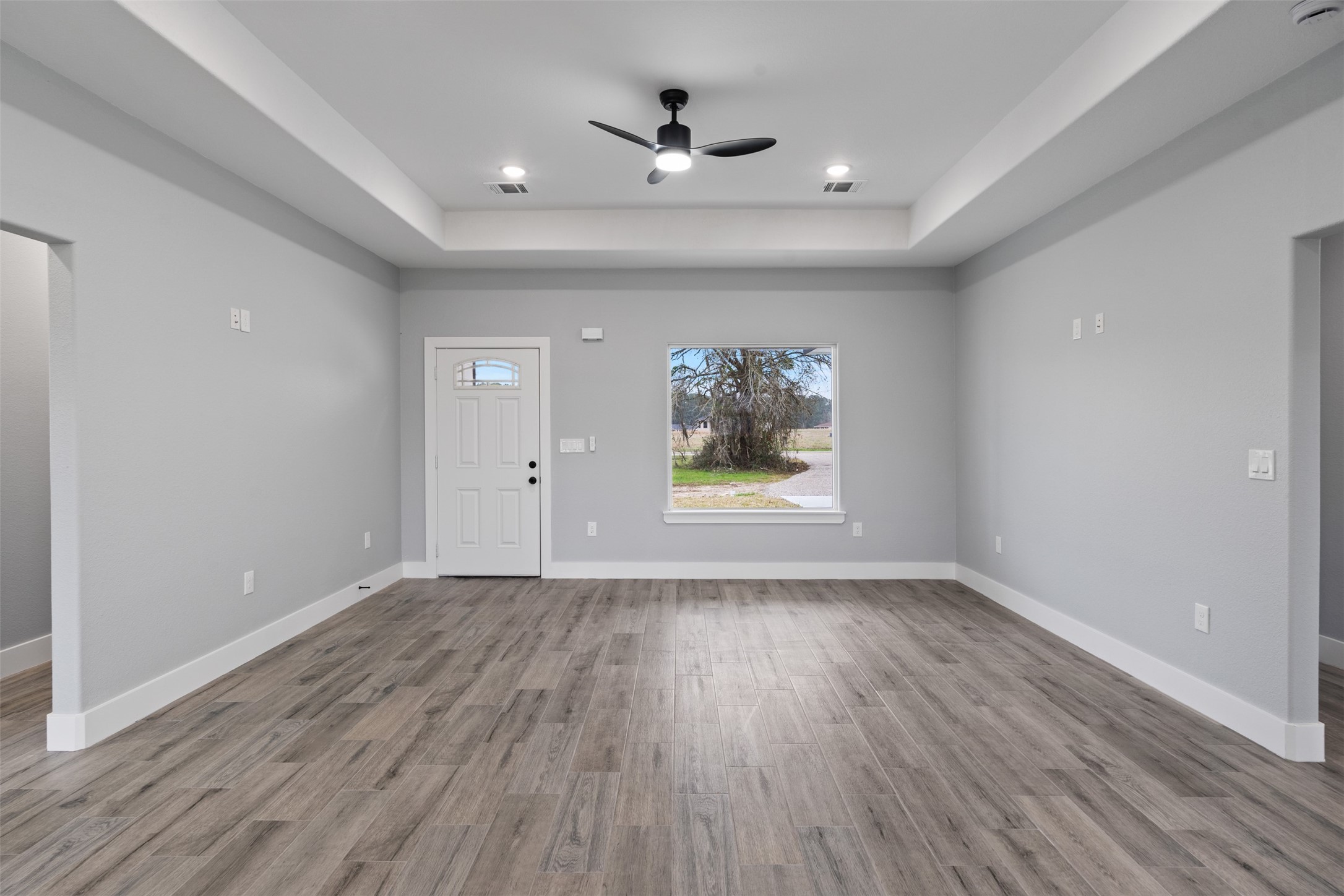 7 Meadowview Drive Trinity, TX 75862 - Photo 8 of 32 wooden floor in an empty room with a window