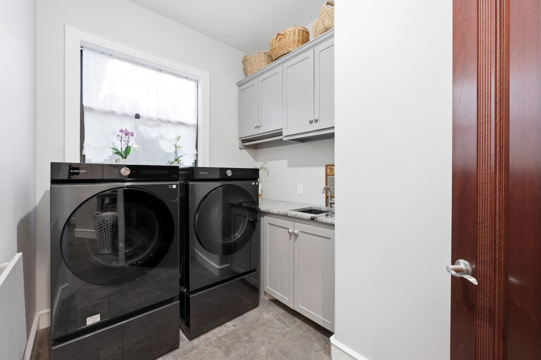 280 Sundog Road Huntsville, TX 77340 - Photo 30 of 50 Laundry room located near the kitchen featuring built-in cabinetry for storage and a convenient utility sink.