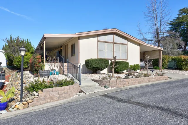 a front view of a house with porch and outdoor seating