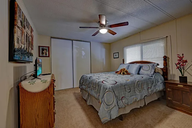 a bedroom with bed and a chandelier