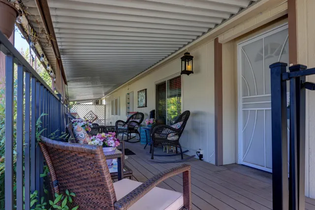 a view of a chairs and table in a balcony