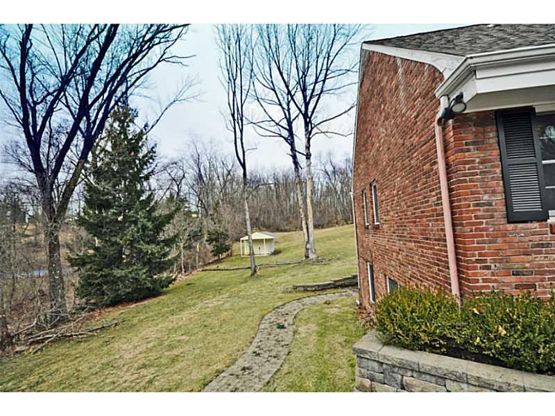 217 Hunt Road Fox Chapel, PA 15215 - Photo 21 of 24 Exterior Back. The brick walkway wraps around the home adjoining the patios and front driveway.