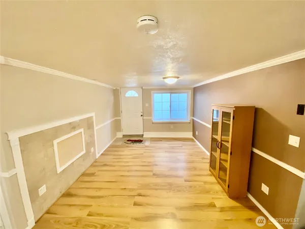 a view of a livingroom with wooden floor and a sink