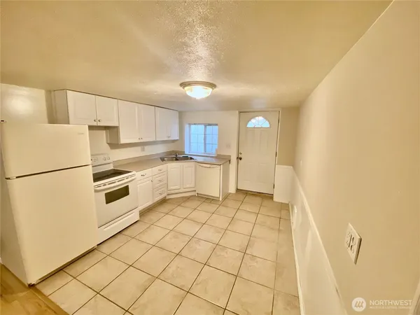 a kitchen with stainless steel appliances a refrigerator sink and cabinets
